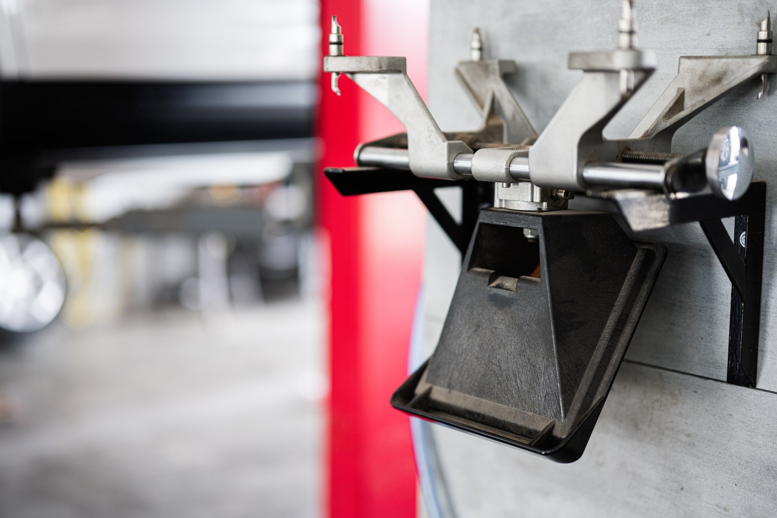 Close-up of wheel alignment tool in auto repair shop